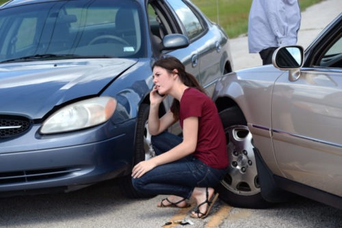 Woman making phone call after auto accident